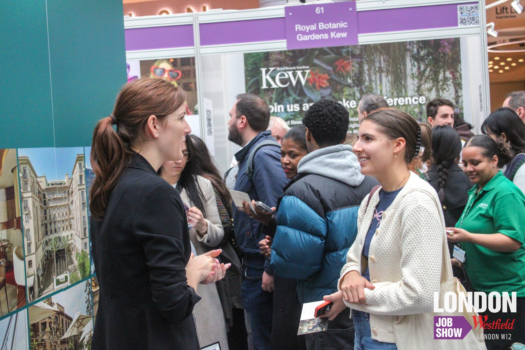 An employer and candidate in conversation at a recruitment stand at the London Job Show