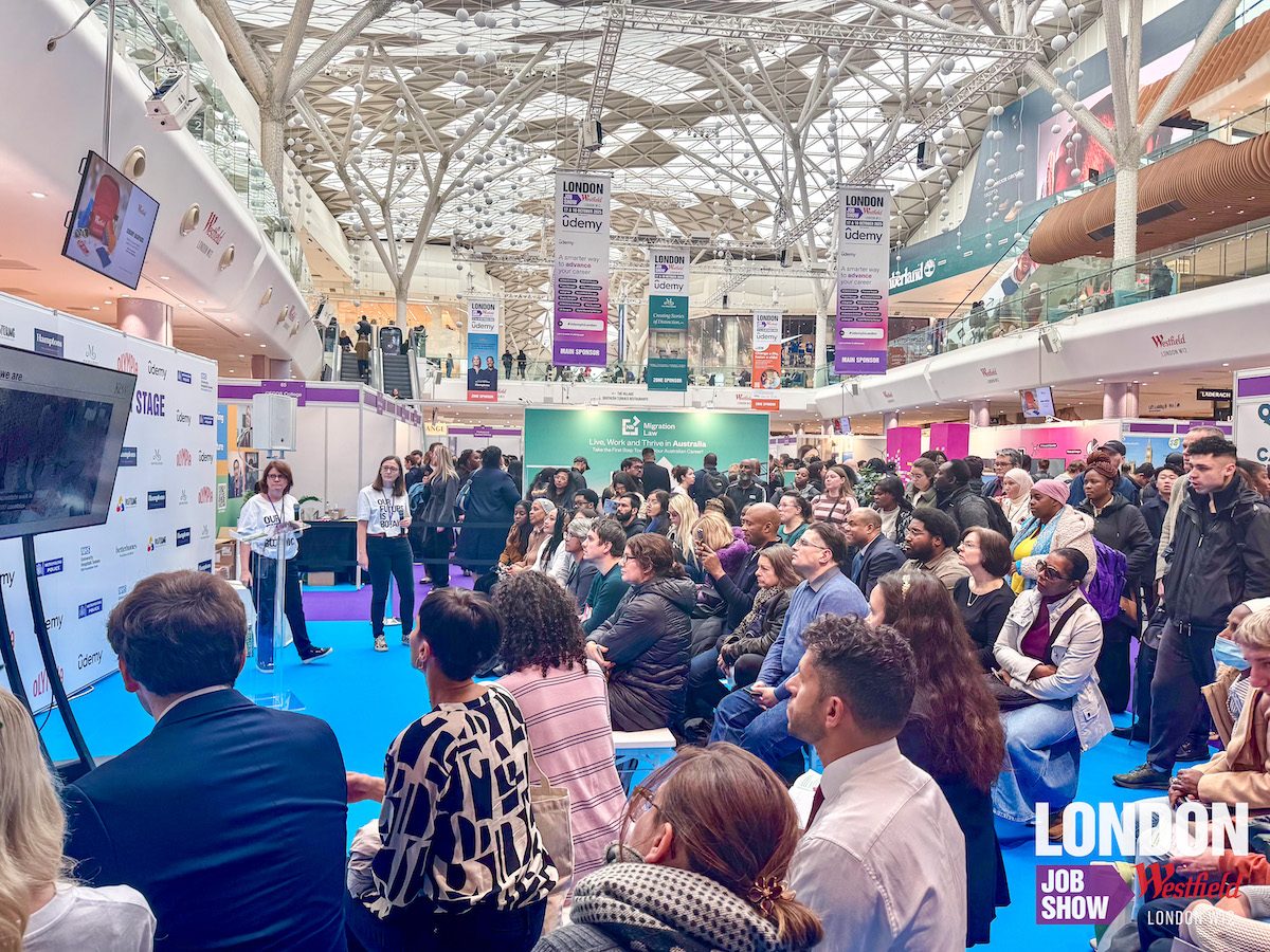 A speaker presenting to an engaged audience at a London Job Show talk