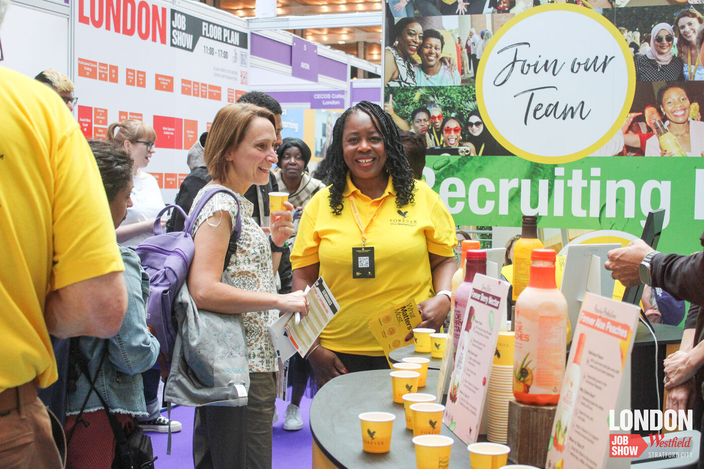An employer and candidate in conversation at a recruitment stand at the London Job Show