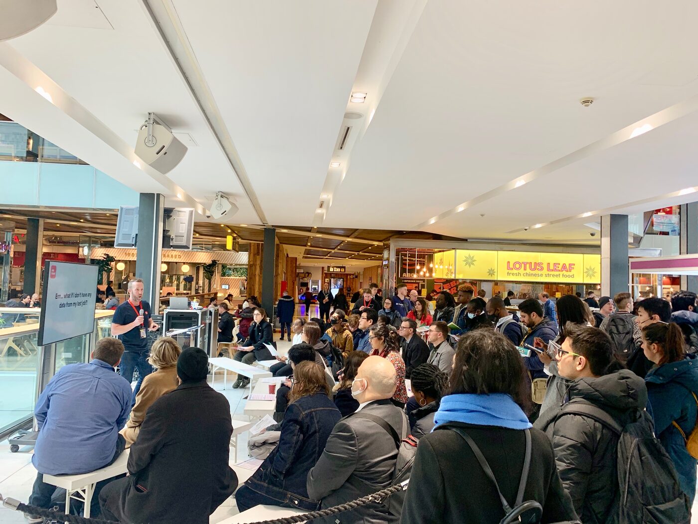 A speaker presenting to an engaged audience at a London Job Show talk
